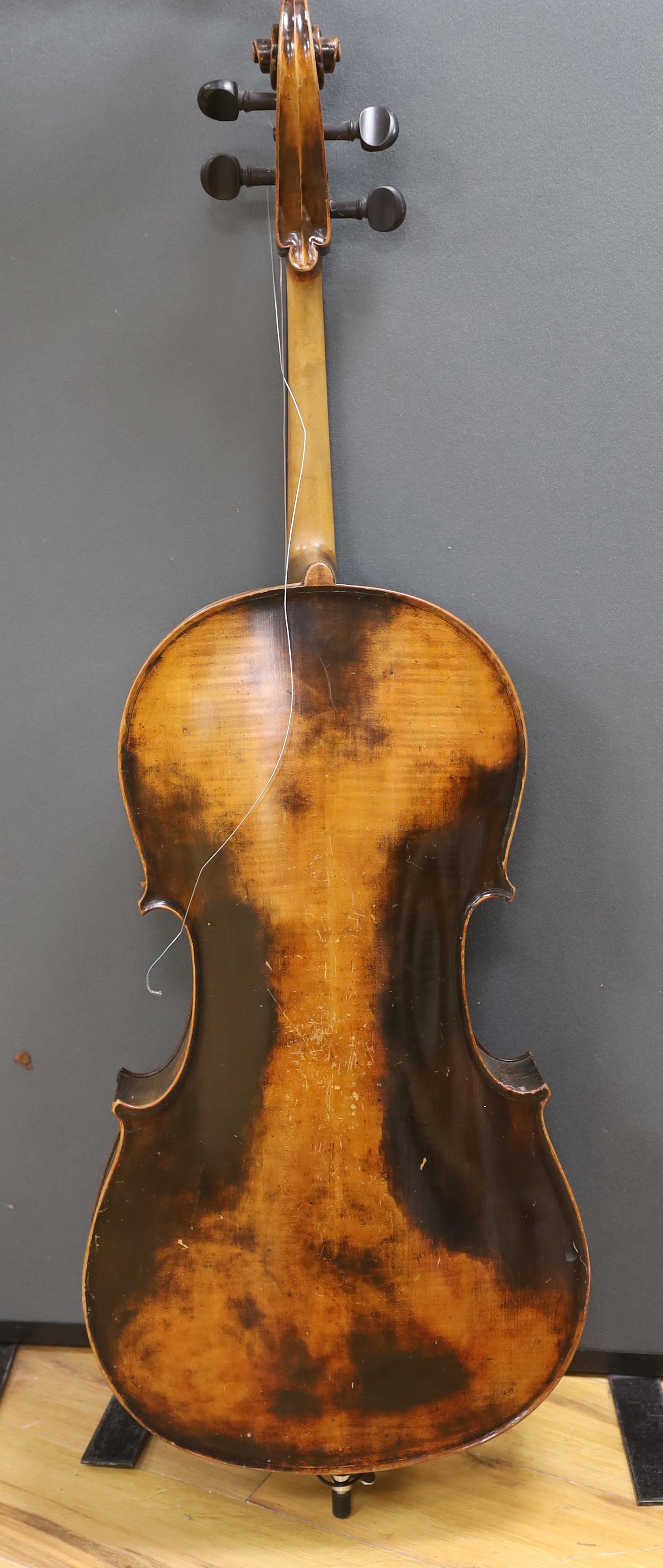 A full size cello labelled Adolf Stowaller, cased, 132cm high
